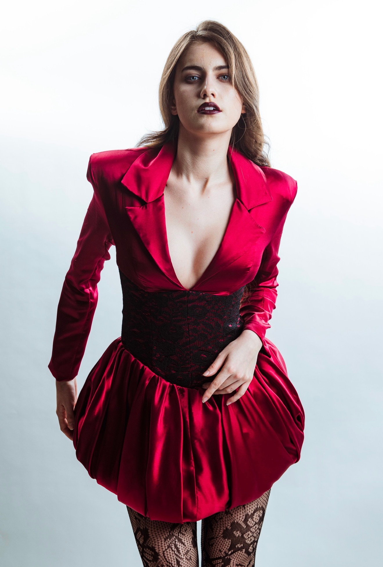 Model wearing a structured red Physalia luxury womenswear garment