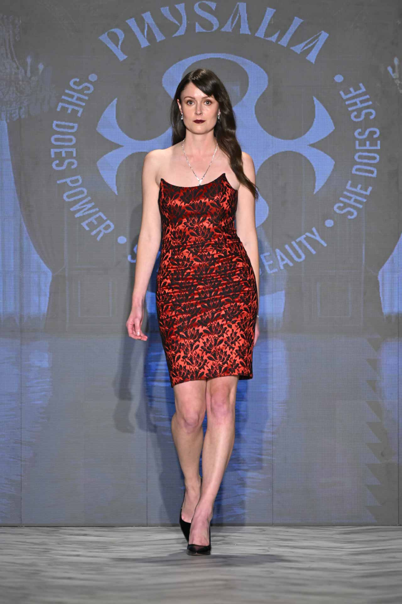 Physalia FASTIGIUM FW2026 Look 1 — strapless red silk and black floral lace cocktail dress