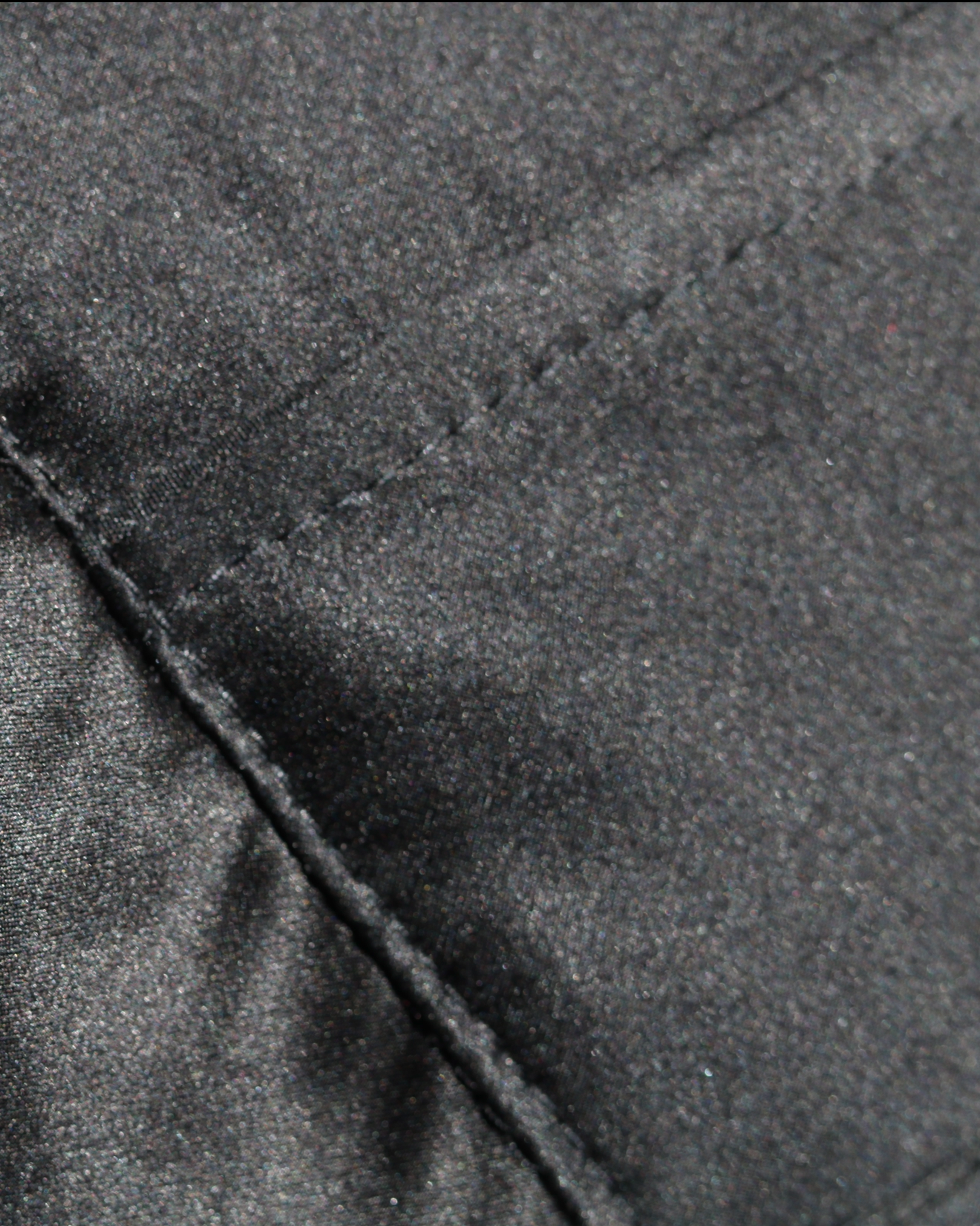 Close-up detail of stitching on a Physalia luxury womenswear garment