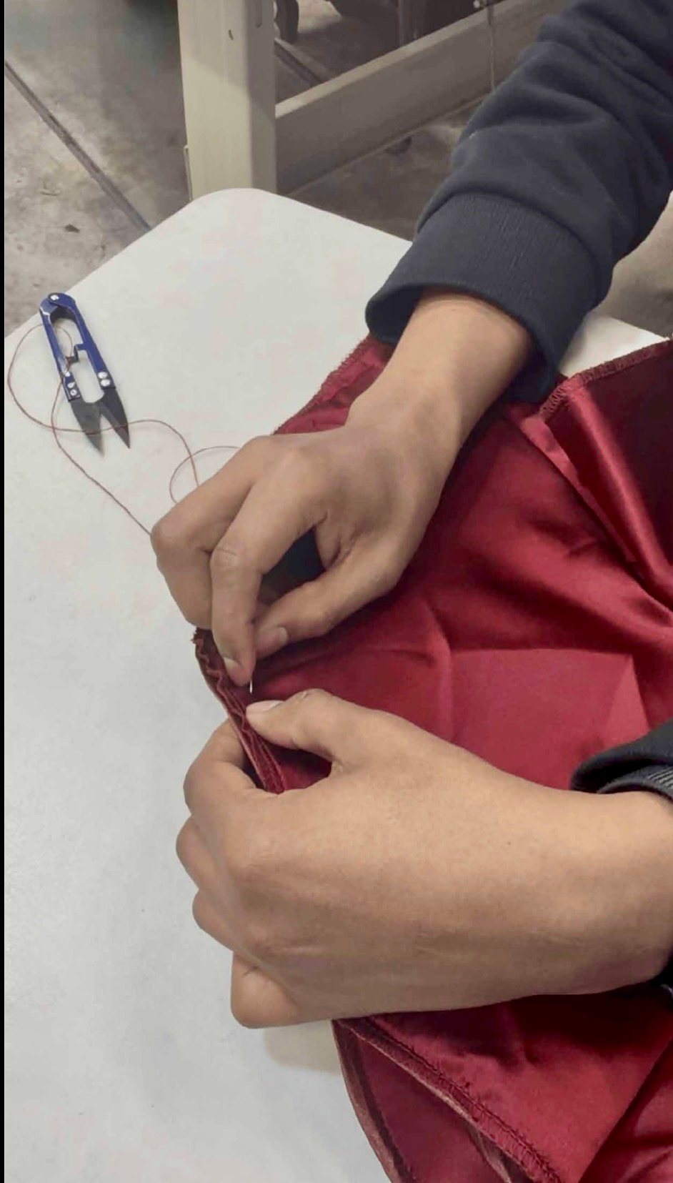 Hand-finished details during Physalia garment production
