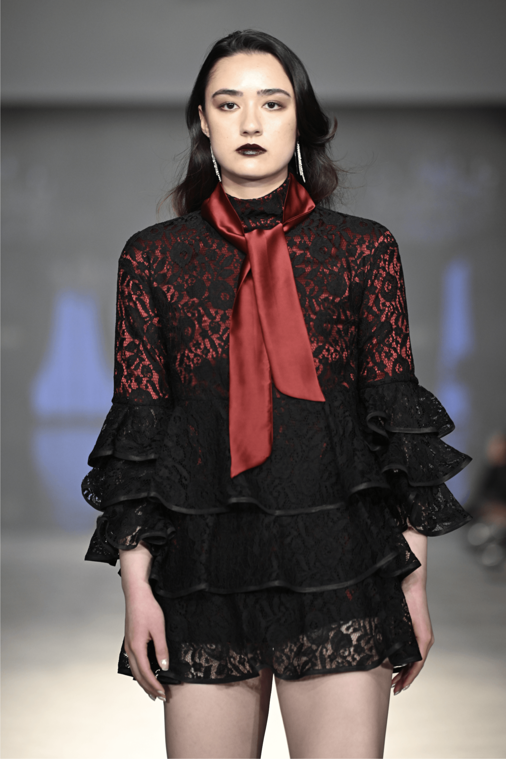 Sheer lace layering detail from the FASTIGIUM FW26 runway