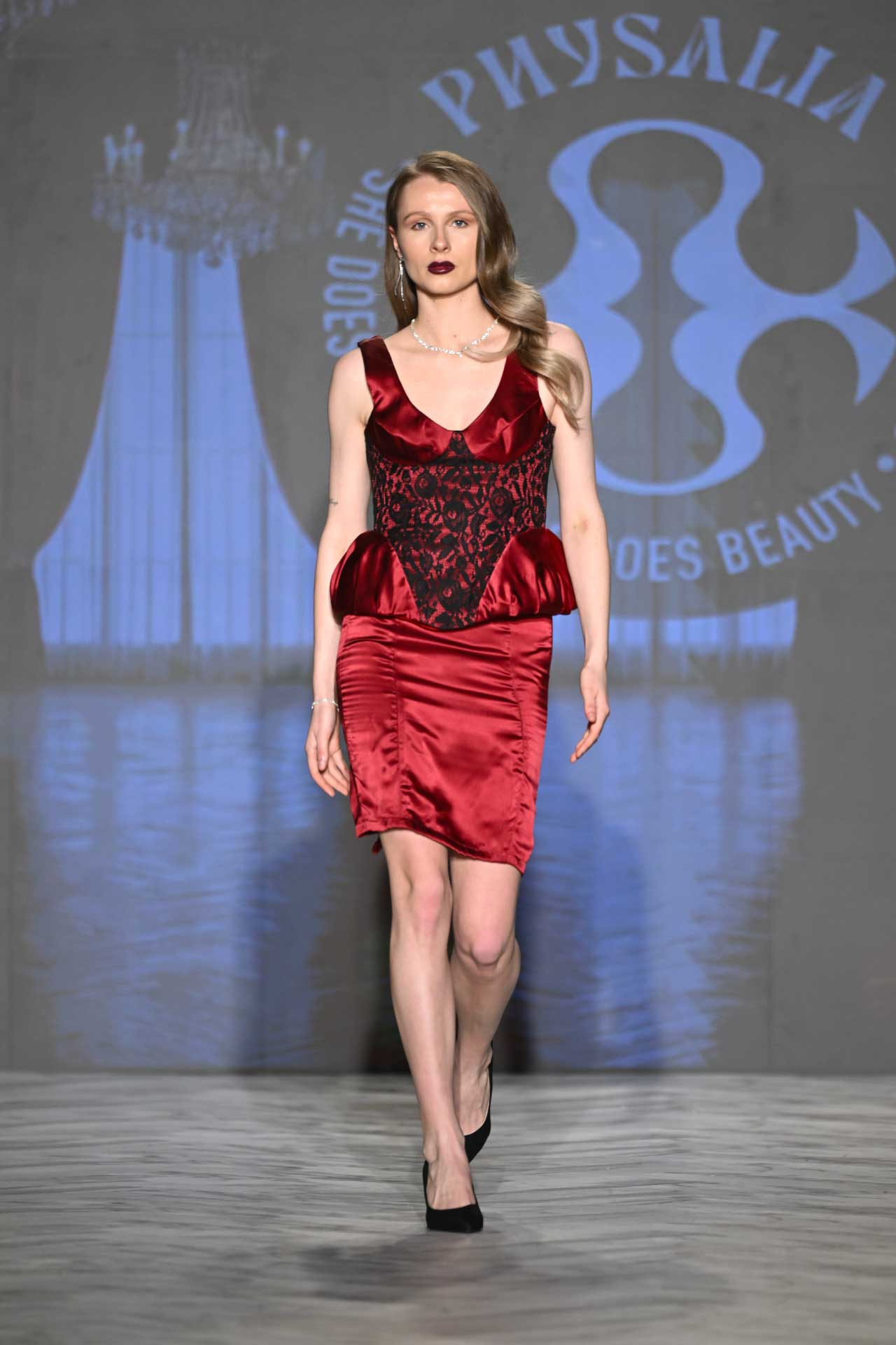 Physalia FASTIGIUM FW2026 Look 2 — dark red silk and black lace corset top with peplum waist and matching silk skirt