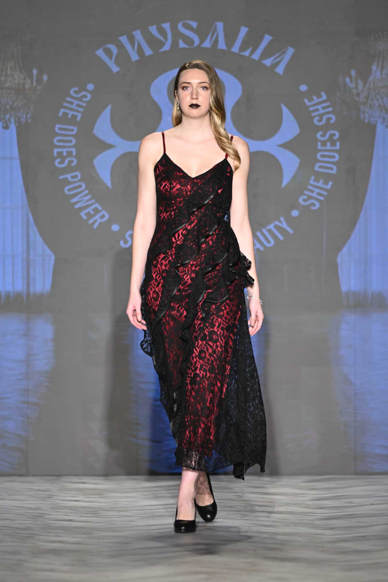 Physalia FASTIGIUM FW2026 Look 4 — black lace slip dress over red silk lining with asymmetrical cascading front ruffle