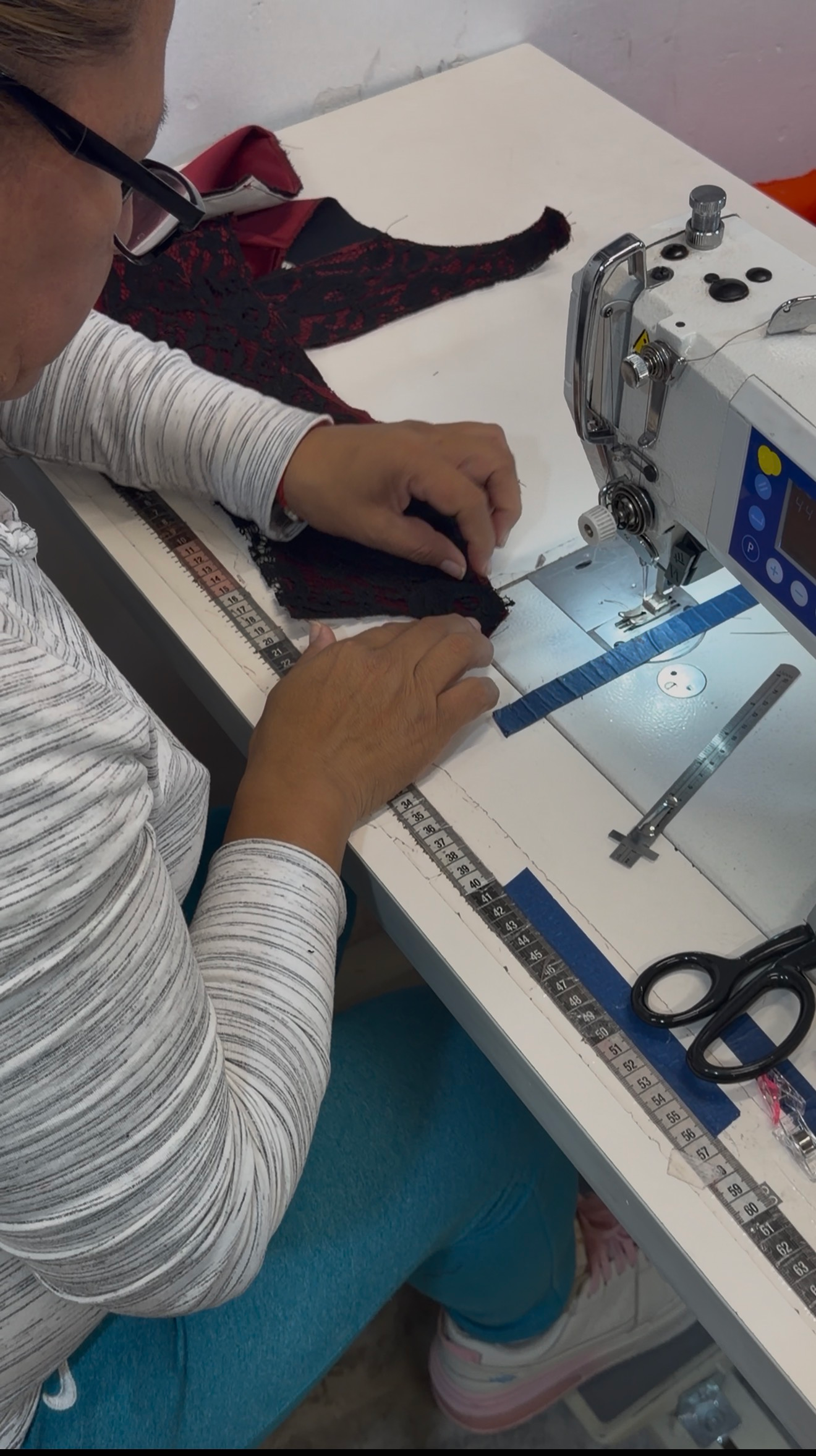 Seamstress sewing a Physalia garment during small batch production in Mexico
